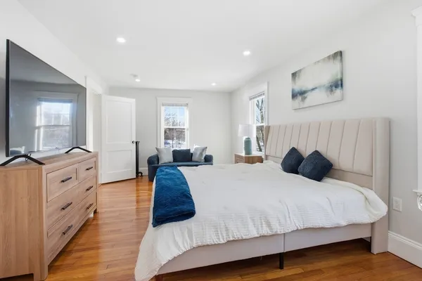 a bedroom with a large bed and a couch