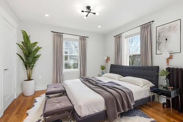 a bedroom with a large bed and a window