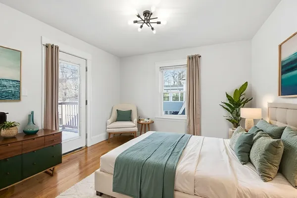 an empty room with wooden floor chandelier fan and windows
