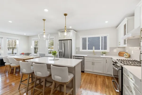 a large kitchen with a table and chairs