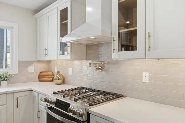 a kitchen with a white stove and cabinets