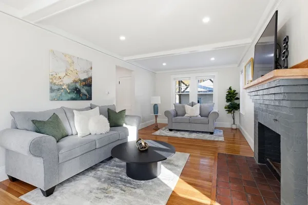 a living room with furniture and a fireplace