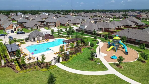 an aerial view of a house with a swimming pool yard and outdoor seating