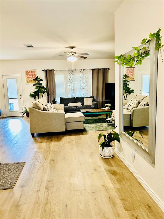 8404 Radiant Street Garland, TX 75043 - Photo 3 of 11 a living room with furniture and a flat screen tv