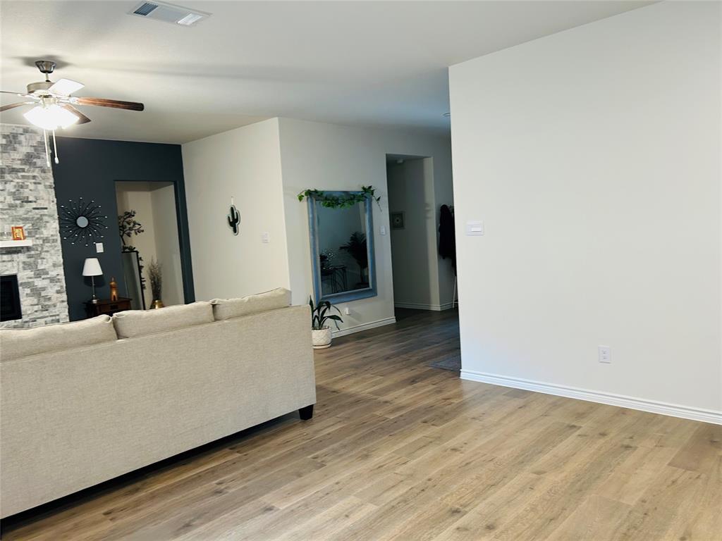 8404 Radiant Street Garland, TX 75043 - Photo 6 of 11 a living room with furniture and a wooden floor