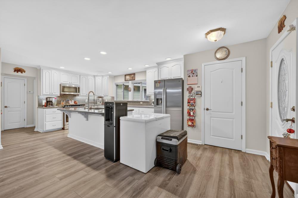 2026 Lily Valley Way West Point, CA 95255 - Photo 19 of 39 a kitchen with white cabinets and stainless steel appliances