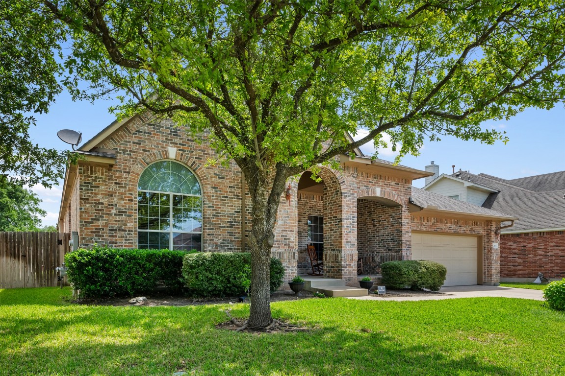 2104 Nelson Ranch Loop Cedar Park, TX 78613 - Photo 1 of 1 front view of a brick house with a yard