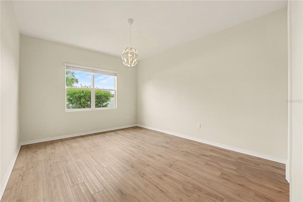 1991 Key Bay Trail Kissimmee, FL 34747 - Photo 11 of 31 an empty room with wooden floor and windows