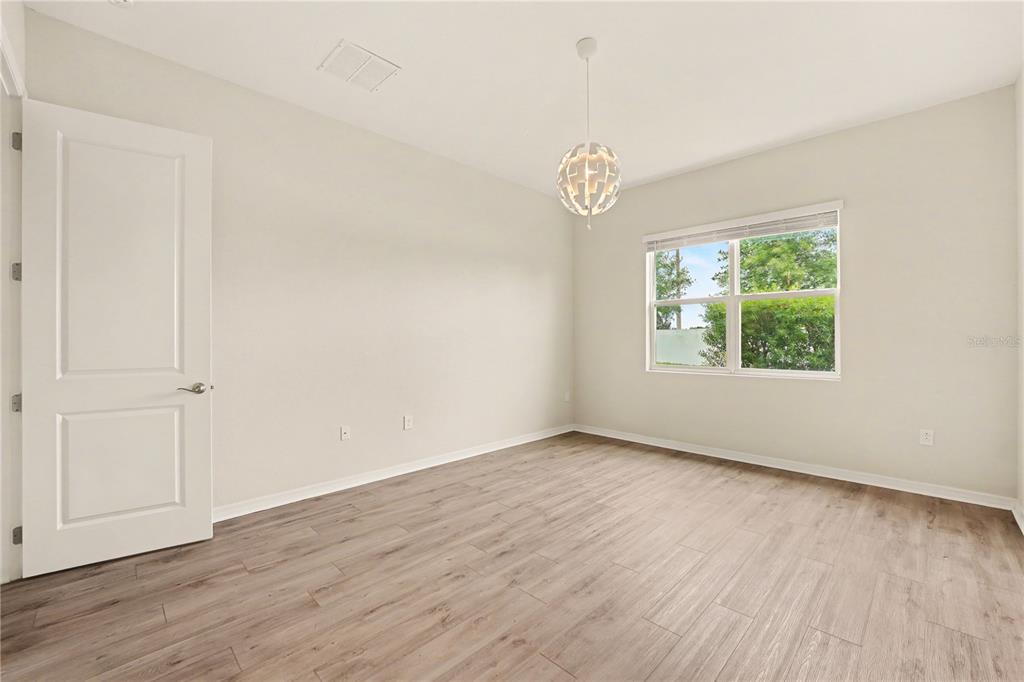 1991 Key Bay Trail Kissimmee, FL 34747 - Photo 12 of 31 an empty room with wooden floor fan and windows