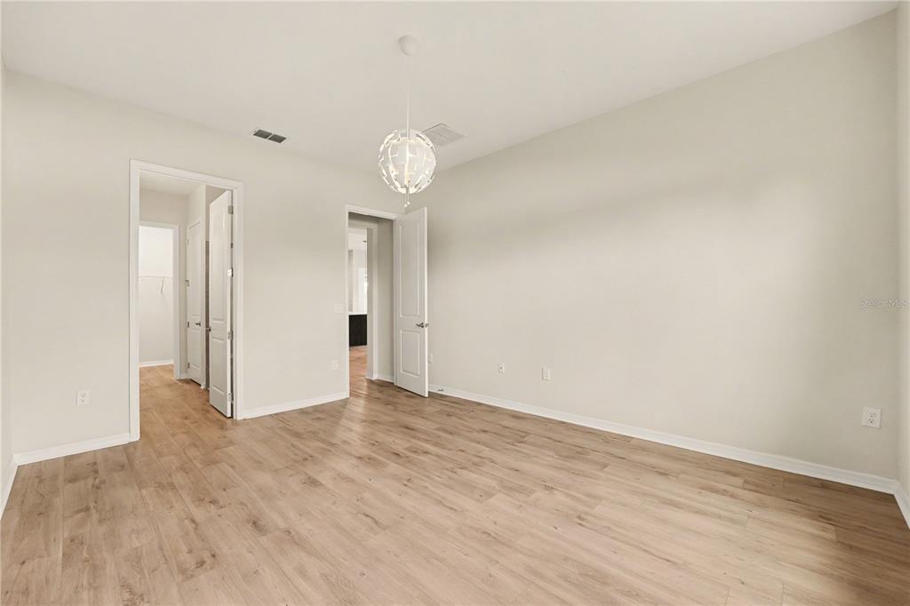 1991 Key Bay Trail Kissimmee, FL 34747 - Photo 13 of 31 a view of an empty room with wooden floor and a window