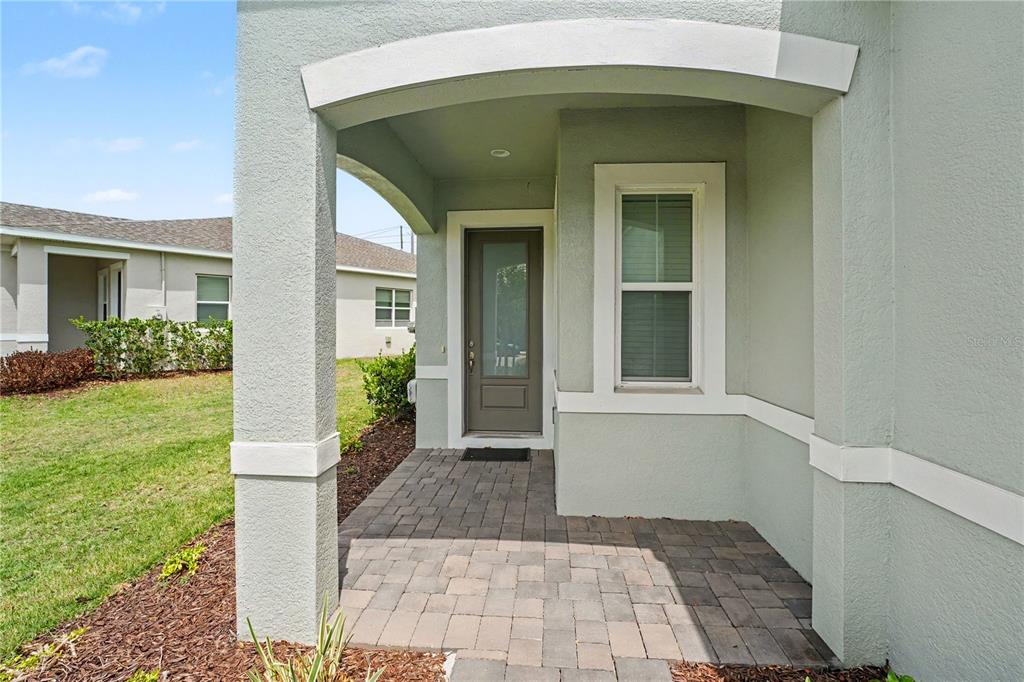 1991 Key Bay Trail Kissimmee, FL 34747 - Photo 2 of 31 a front view of a house with garden
