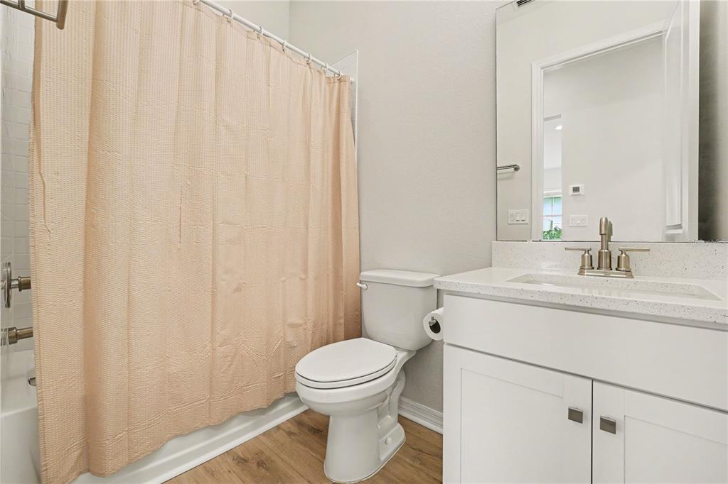 1991 Key Bay Trail Kissimmee, FL 34747 - Photo 21 of 31 a bathroom with a sink a toilet and shower curtain