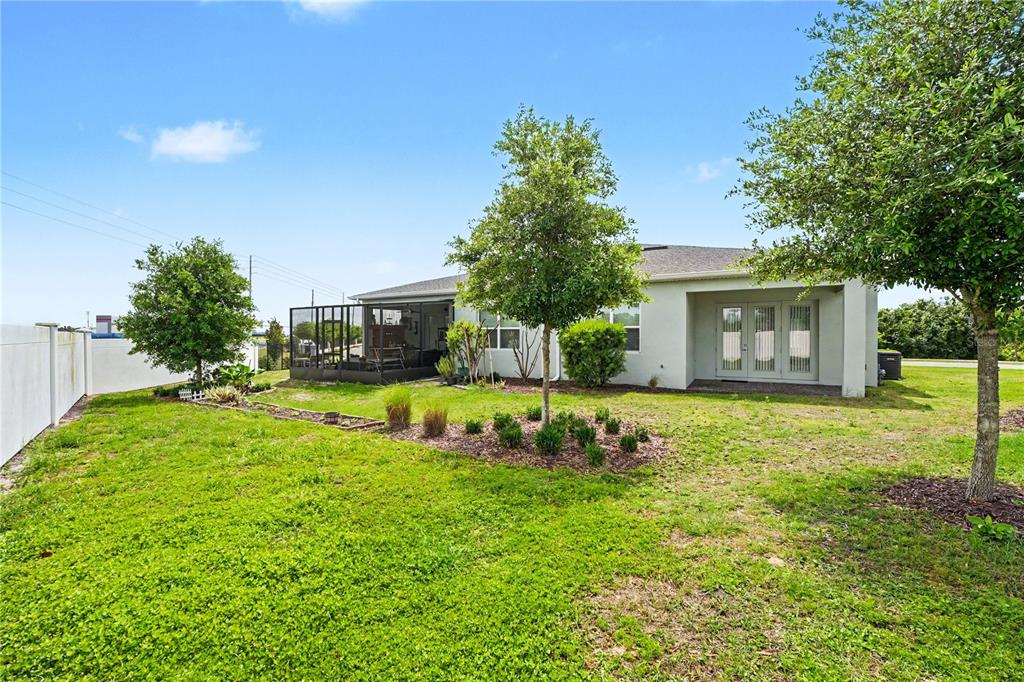 1991 Key Bay Trail Kissimmee, FL 34747 - Photo 26 of 31 a view of a house with a big yard and large tree