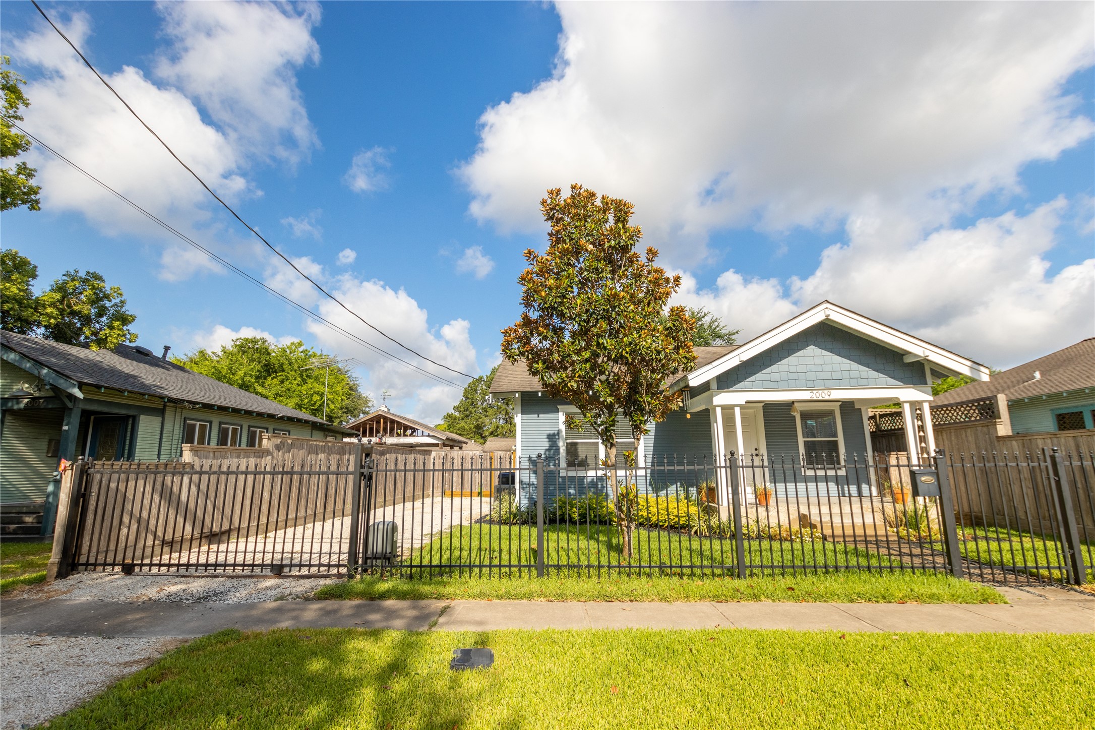 2009 Singleton Street Houston, TX 77008 - Photo 3 of 24 a view of a house with a big yard and a garden