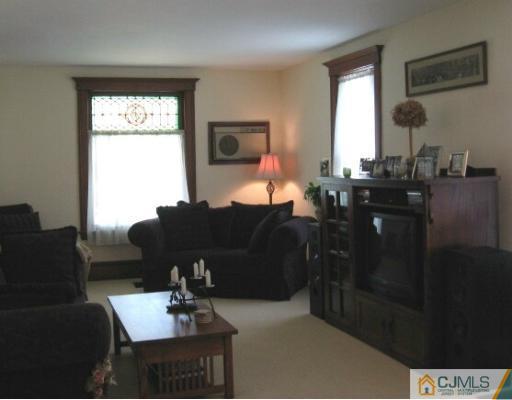 340 New Market Road Dunellen, NJ 08812 - Photo 3 of 8 a living room with furniture and a window
