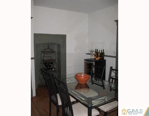 340 New Market Road Dunellen, NJ 08812 - Photo 4 of 8 a view of a workspace with furniture and wooden floor