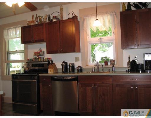 340 New Market Road Dunellen, NJ 08812 - Photo 5 of 8 a kitchen with granite countertop a sink cabinets and window