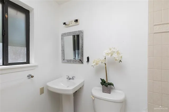 a view of an empty room with closet and wooden floor