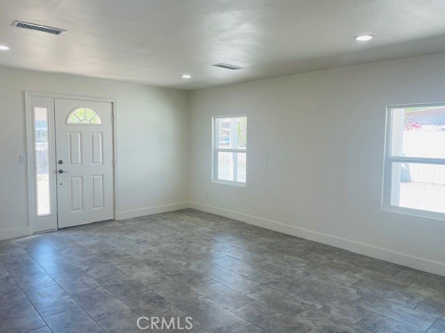 73882 Santa Rosa Way Palm Desert, CA 92260 - Photo 3 of 11 an empty room with wooden floor and windows
