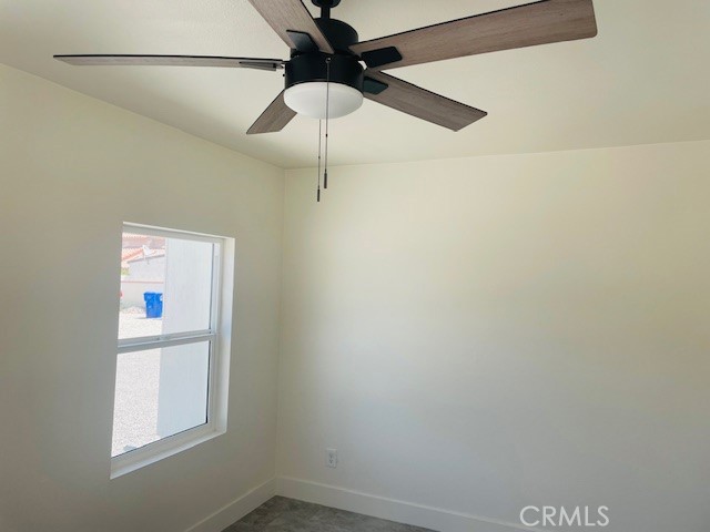 73882 Santa Rosa Way Palm Desert, CA 92260 - Photo 7 of 11 an empty room with a window and a fan