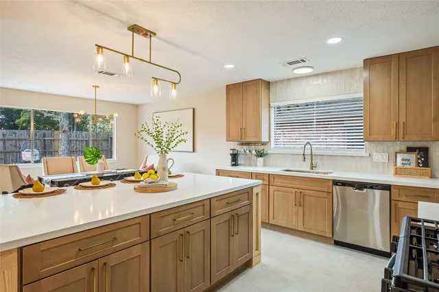 a kitchen with sink stove and cabinets