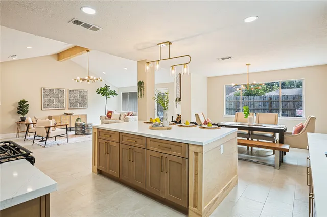 a open kitchen with a sink and living room view