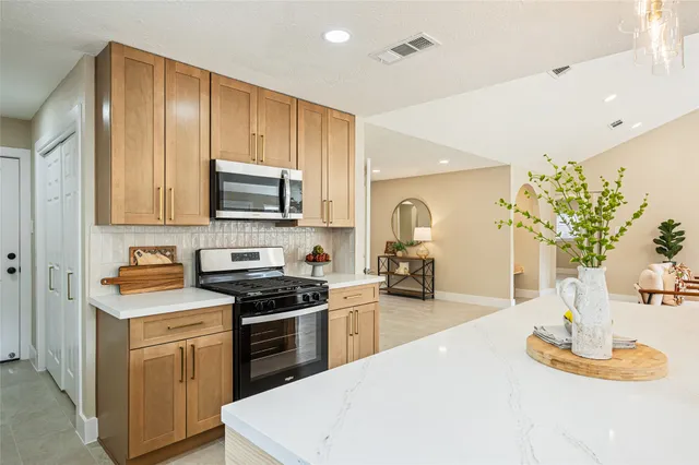 a kitchen with sink a microwave and cabinets