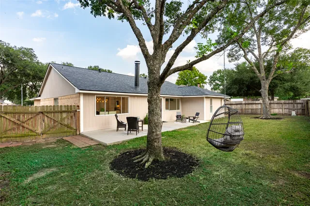a house view with a sitting space and garden