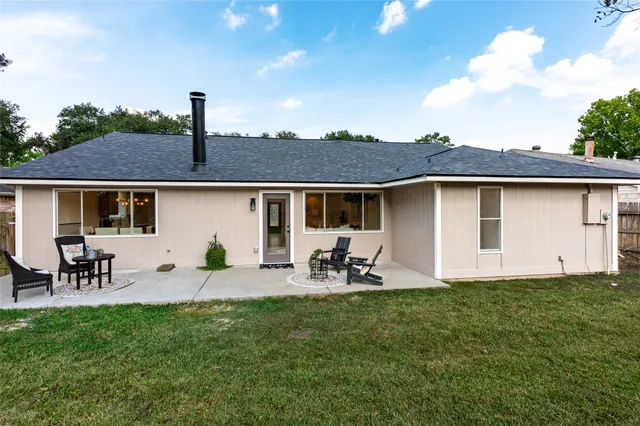a front view of house with yard and outdoor seating