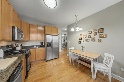 a kitchen with refrigerator cabinets and wooden floor