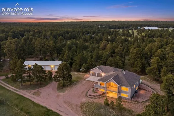 an aerial view of a house with a yard