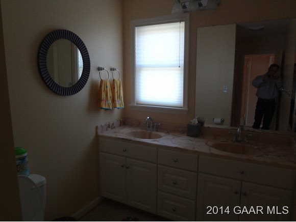 295 Summerdean Road Middlebrook, VA 24459 - Photo 8 of 8 a bathroom with a granite countertop sink a mirror and a window