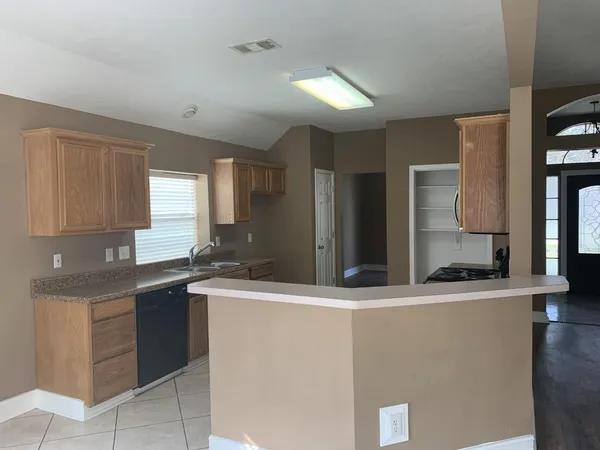 a kitchen with stainless steel appliances granite countertop a sink and a refrigerator