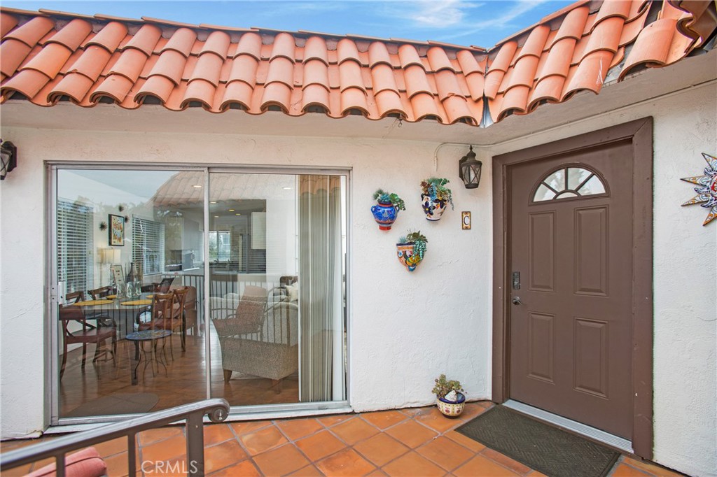 140 Avenida Algodon, Unit C San Clemente, CA 92672 - Photo 13 of 14 a room with painting on the wall and a table