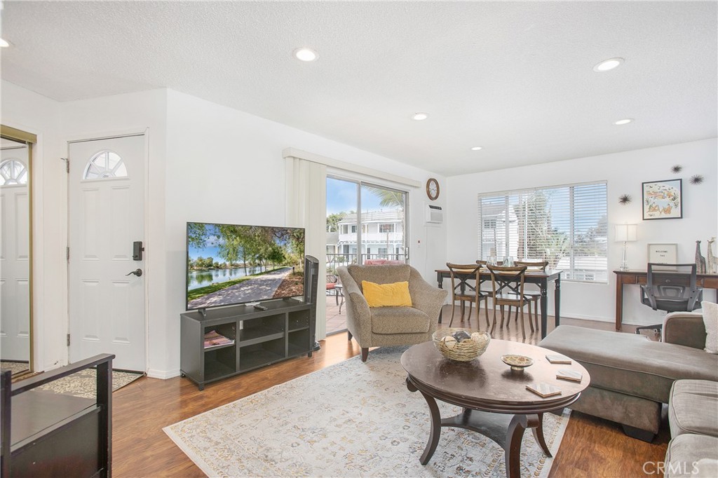 140 Avenida Algodon, Unit C San Clemente, CA 92672 - Photo 2 of 14 a living room with furniture a rug and a flat screen tv
