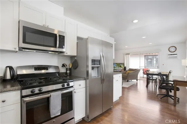 a kitchen with stainless steel appliances a stove microwave and cabinets