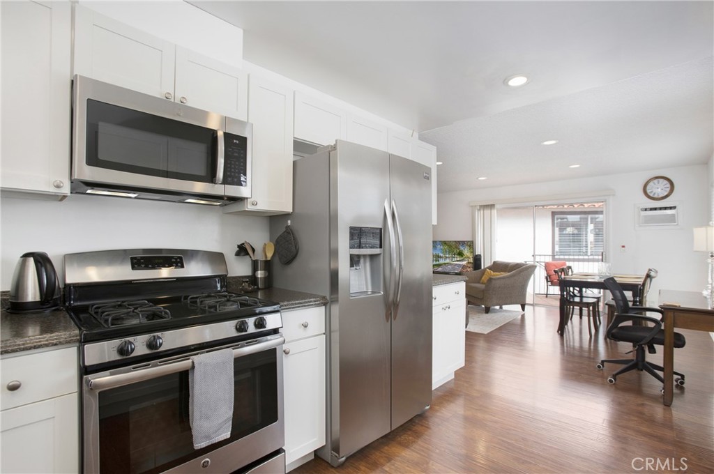140 Avenida Algodon, Unit C San Clemente, CA 92672 - Photo 5 of 14 a kitchen with stainless steel appliances a stove microwave and cabinets