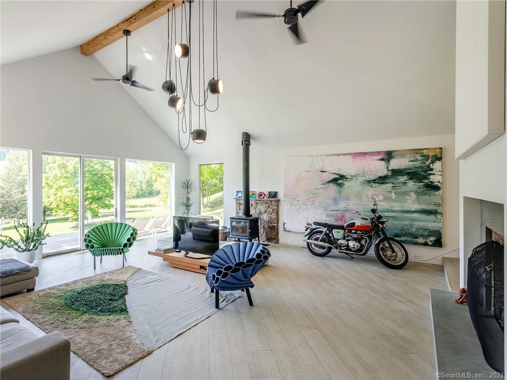 110 Geer Mountain Road Kent, CT 06785 - Photo 14 of 40 a view of a livingroom with furniture water and a patio