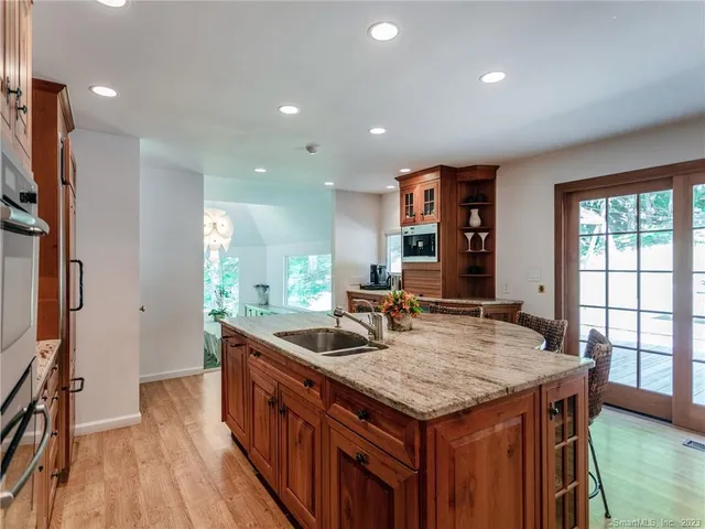 a kitchen with granite countertop a stove and a sink