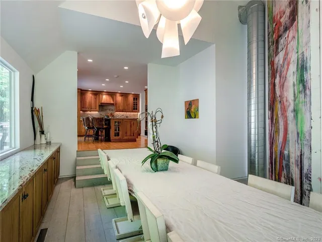 a dining room with kitchen island granite countertop furniture and a chandelier