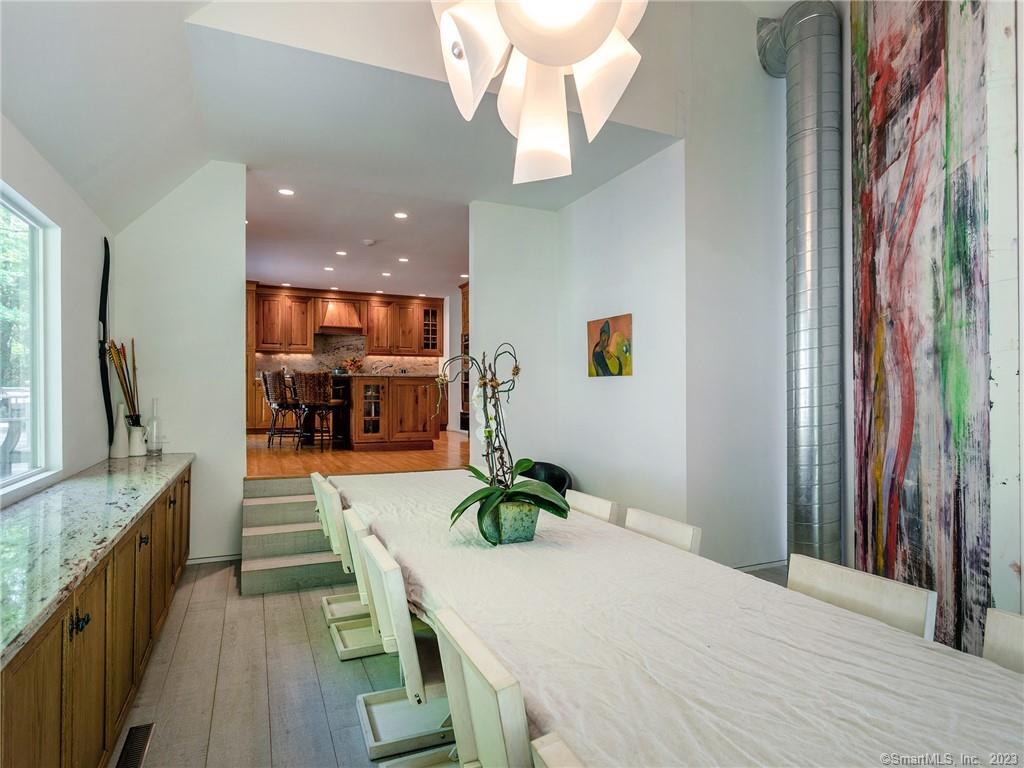 110 Geer Mountain Road Kent, CT 06785 - Photo 18 of 40 a dining room with kitchen island granite countertop furniture and a chandelier