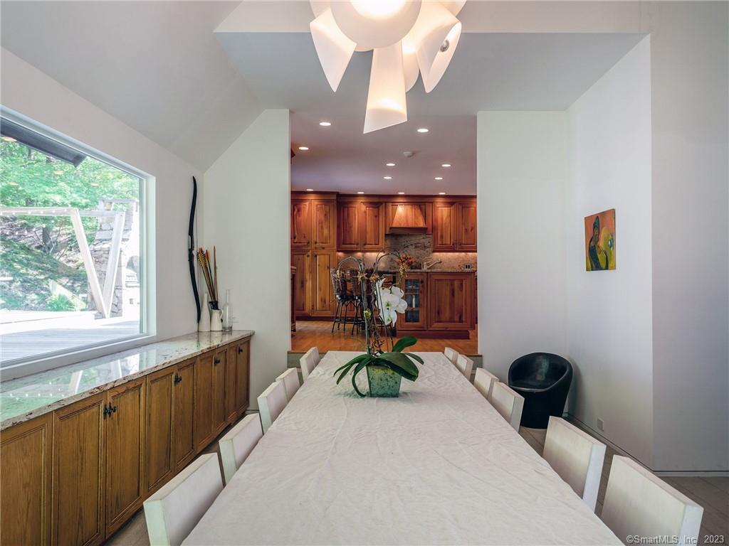 110 Geer Mountain Road Kent, CT 06785 - Photo 19 of 40 a living room with furniture a window and a chandelier