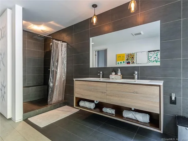 a bathroom with a sink a mirror and a shower