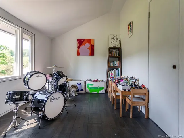 a view of a dining room filled with furniture wooden floor and a chandelier