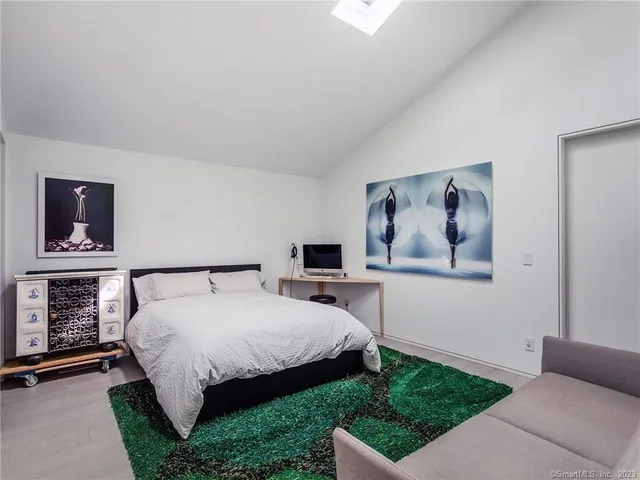 a bedroom with a bed and a television