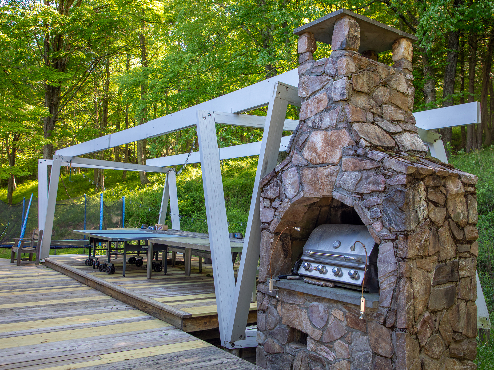 110 Geer Mountain Road Kent, CT 06785 - Photo 37 of 40 a roof deck with table and chairs a barbeque with a small yard