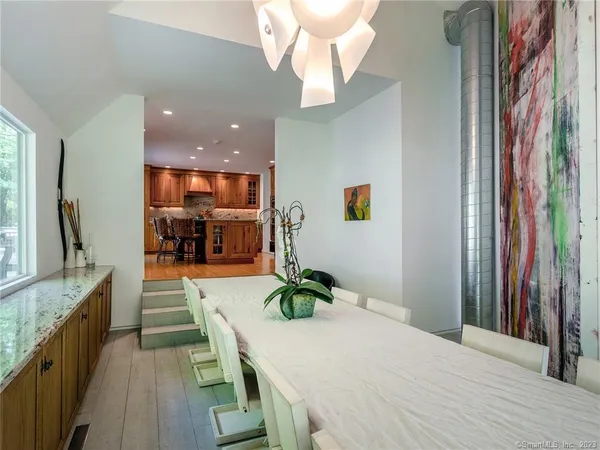 a dining room with kitchen island granite countertop furniture and a chandelier
