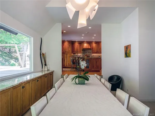 a living room with furniture a window and a chandelier