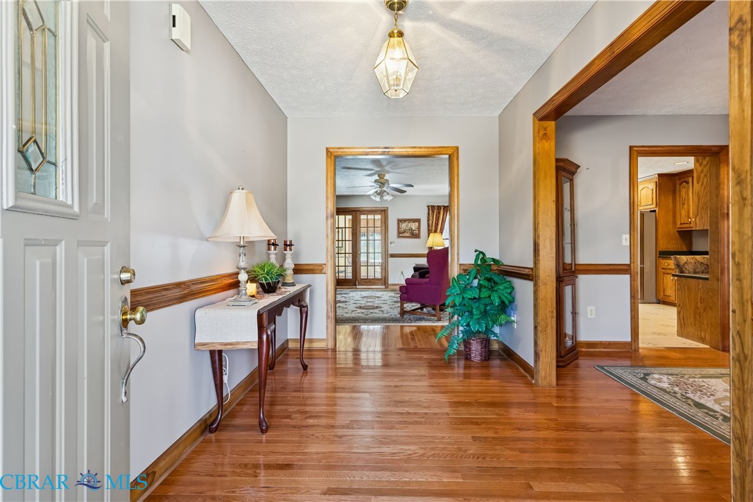 6253 Ark Road Gloucester, VA 23061 - Photo 3 of 38 Foyer featuring light wood-style floors, a textured ceiling, and ceiling fan