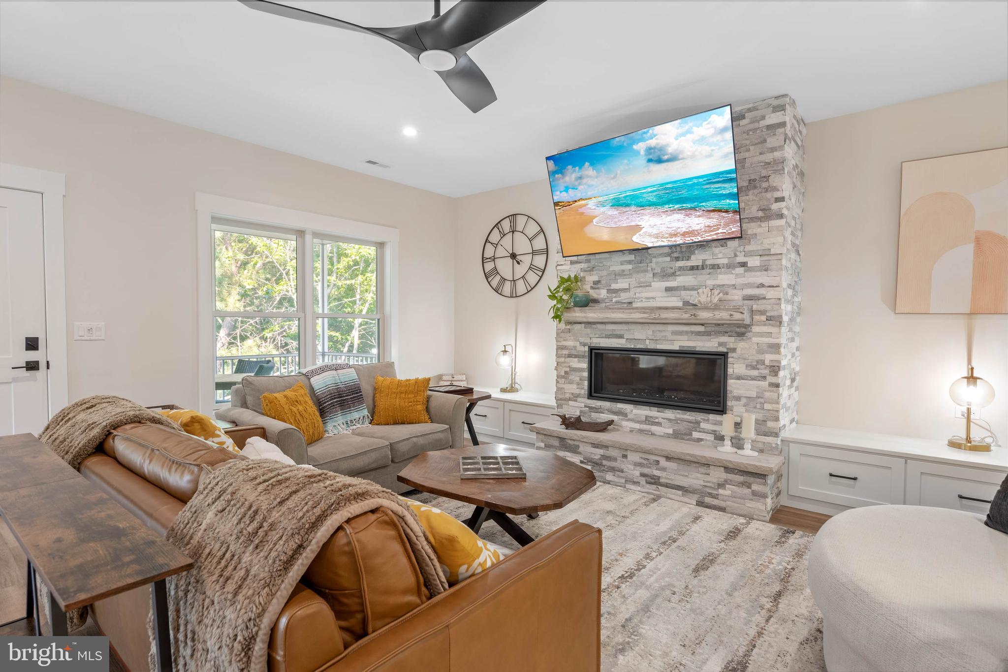 38155 Muddy Neck Road Ocean View, DE 19970 - Photo 18 of 67 a living room with furniture a fireplace and a flat screen tv